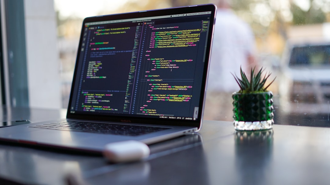 Home Laptop with code and plant in coffee shop